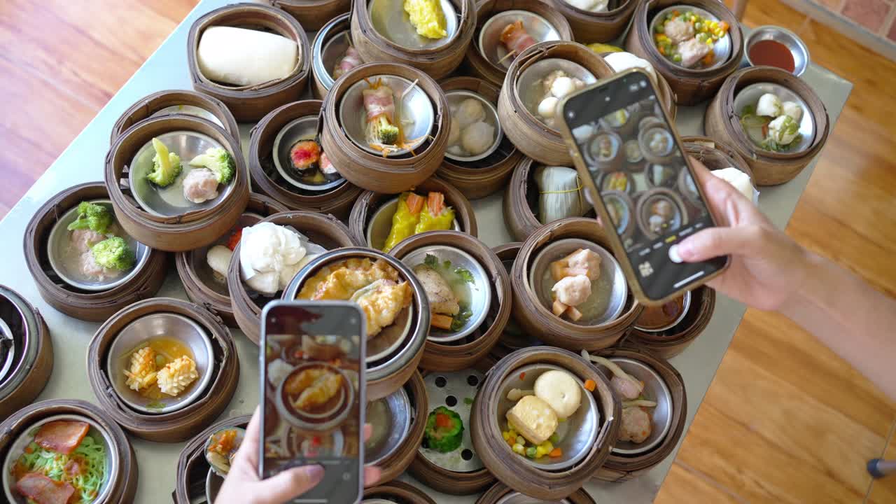 4K Top view of Asian woman using mobile phone photography Chinese food steamed dumpling on the table