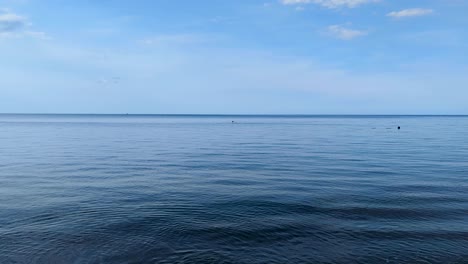 a person snorkeling on the horizon in ocean at amed on tropical island of bali indonesia