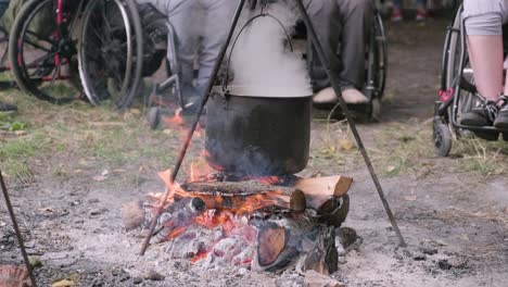 people with disabilities sitting around a bonfire