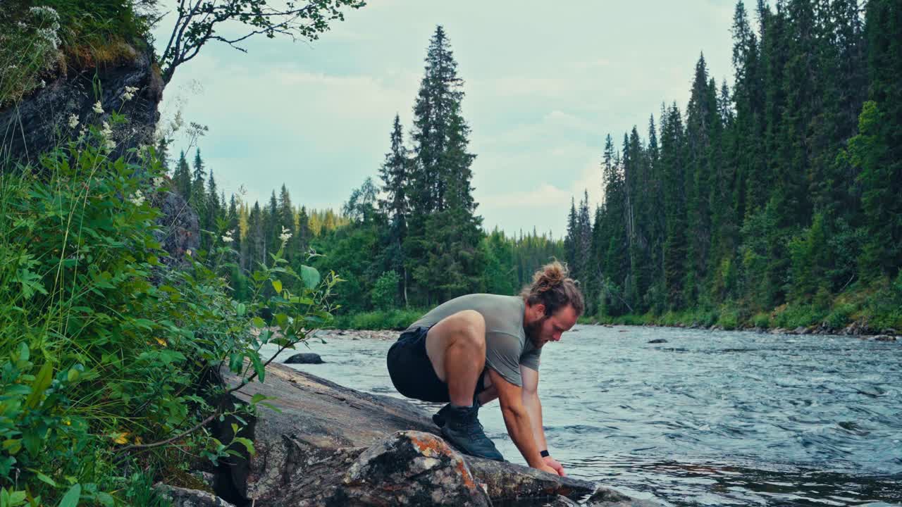 Norwegian Guy Drinking Water From A Flowing Freshwater River Mountain. Static Shot