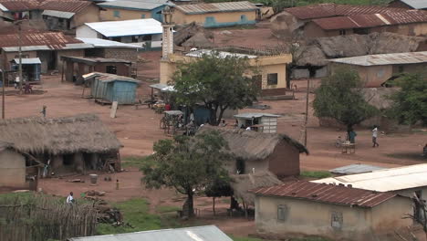 the people of a small african village go about their afternoon activities