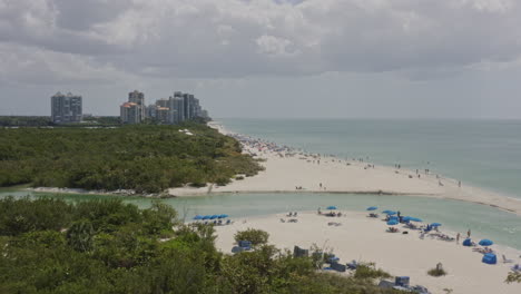 North-Naples-Florida-Aerial-v14-low-flyover-by-a-crowded-Clam-Pass-beach---March-2020
