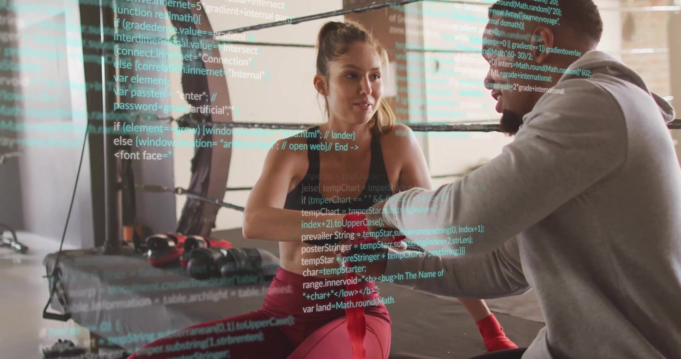 Trainer unrolling red hand wrap spiraling around athlete wrist in boxing gym preparing for sparring
