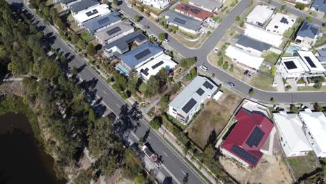 vista aérea de un barrio australiano con grandes casas familiares cerca de un lago artificial