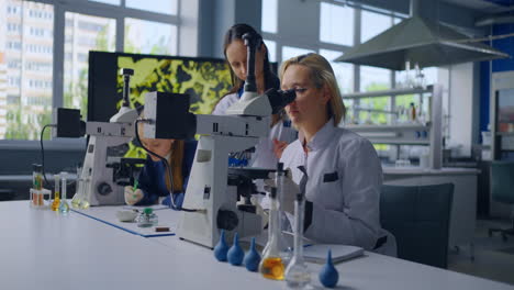 science students learning with microscopes