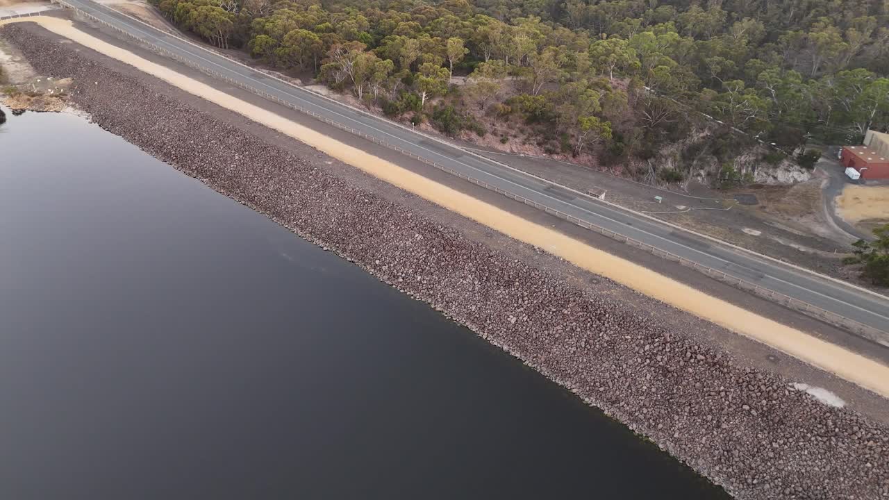 Aerial View of a Dam and Reservoir with Access Tower and Bridge