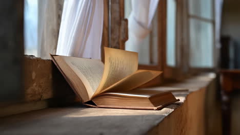 open book on a window sill