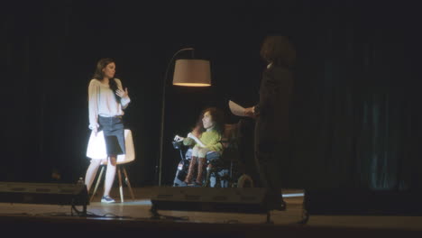 woman in wheelchair on stage
