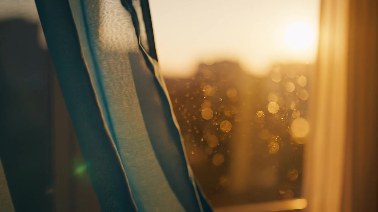 Golden sunlight shining through a sheer window curtain