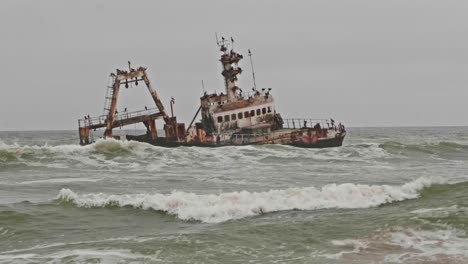 tilt up revealing eerie shipwreck along namibia skeleton coast on overcast day