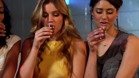 cute friends having shots at a party