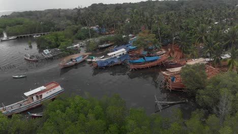 wide shot of local boat construction site at belitung island indonesia, aerial