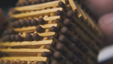 person-turns-toy-house-made-from-matches-extreme-close-view