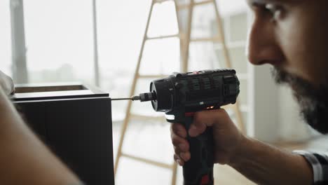 Close-up-video-of-carpenter-using-a-cordless-drill