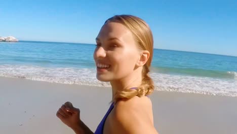 Young-woman-jogging-on-beach