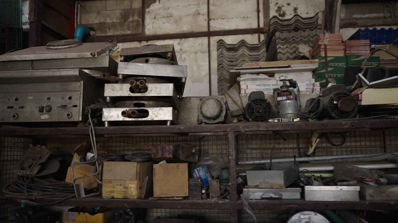 Cluttered Industrial Storage Shelf with Old Machinery and Building Materials