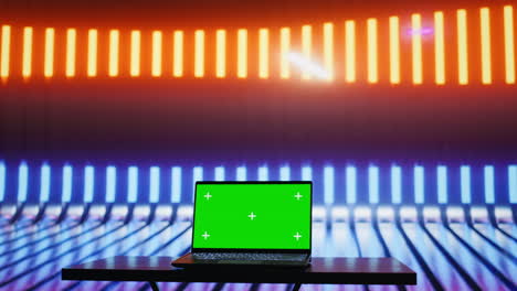 Empty space with colorful neon lights and an isolated laptop display