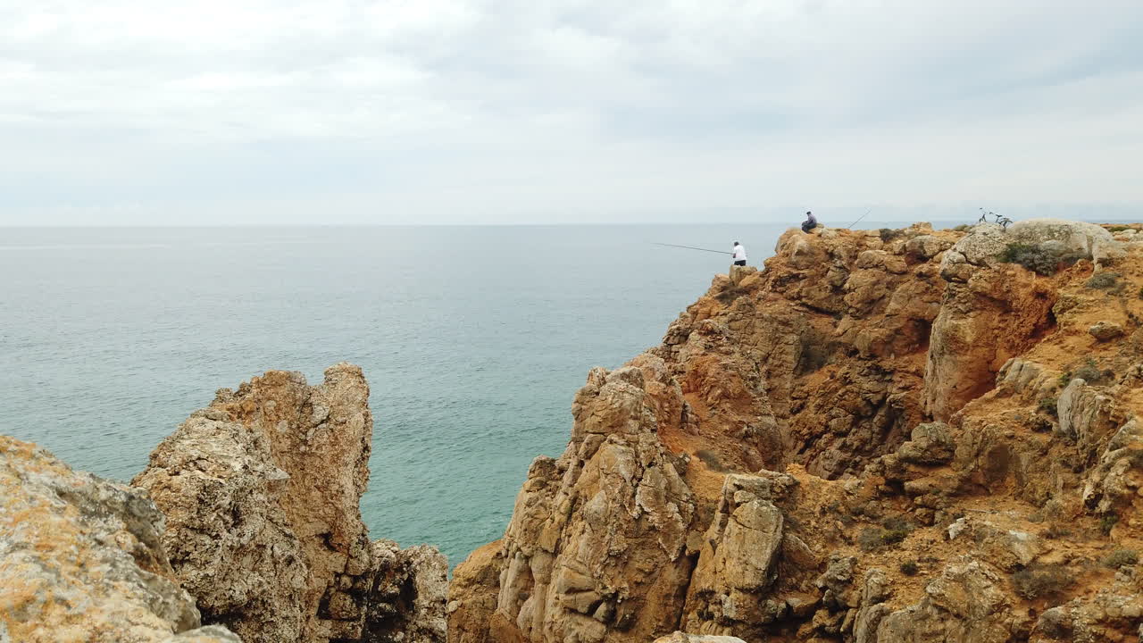 Fisherman fishing from a cliff in southern Portugal, Sagres