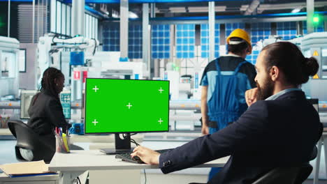 photovoltaics factory worker analyzes data on green screen pc, reviewing metrics