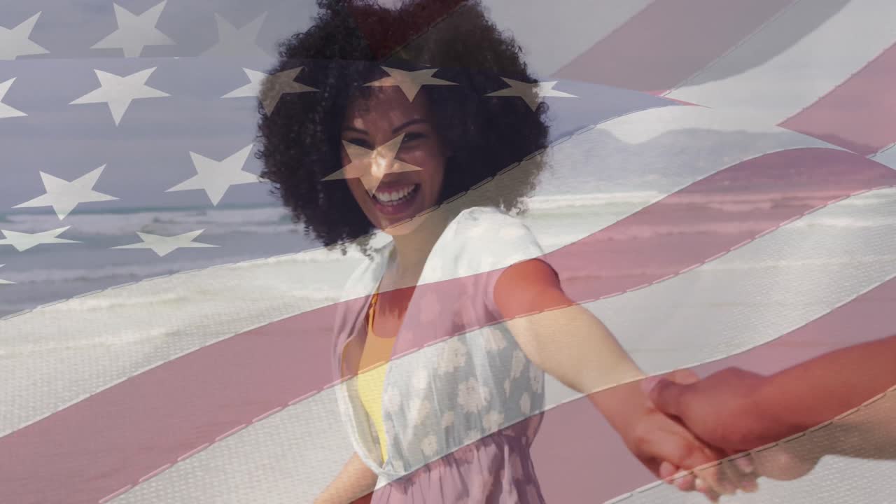 animación de la bandera de los estados unidos sobre una feliz pareja afroamericana en la playa