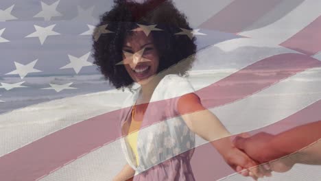 animation of flag of usa over happy african american couple on beach