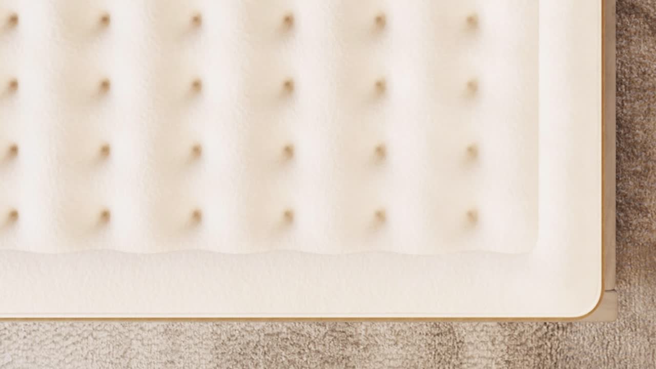 Camera descends toward plush memory-foam texture on fresh mattress