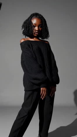 fashion studio shoot of a young black woman in black attire