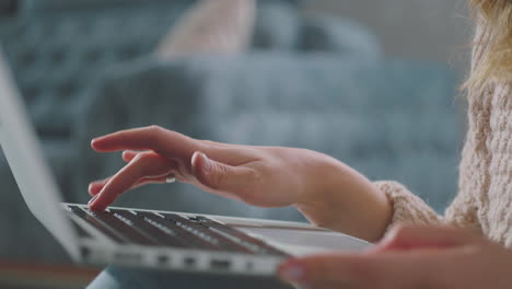 woman's hand typing on laptop