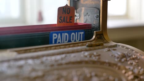 no sale pop up tag on the top of an antique cash register