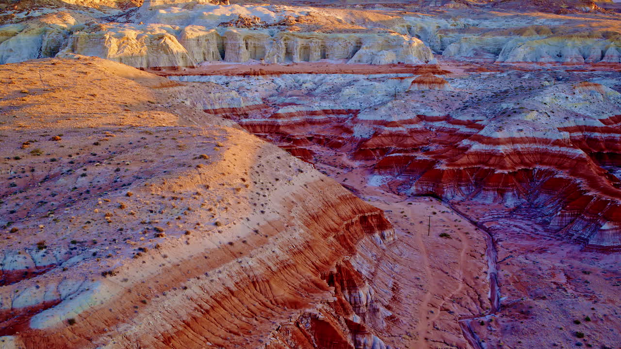 A slow, sweeping drone shot reveals the colorful, rugged terrain and hoodoos near the Utah-Arizona border.