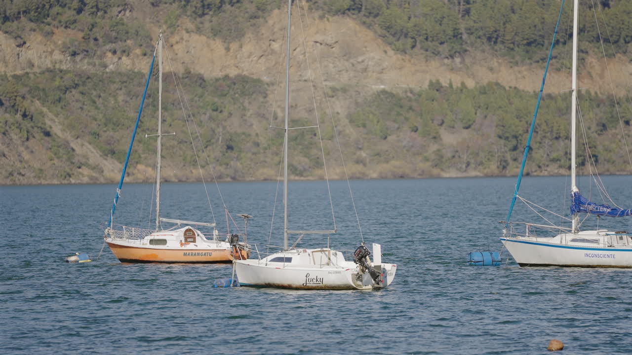 Sailboats floating on Lake Lácar during summer in tourist town of San Martín de los Andes, Argentina.