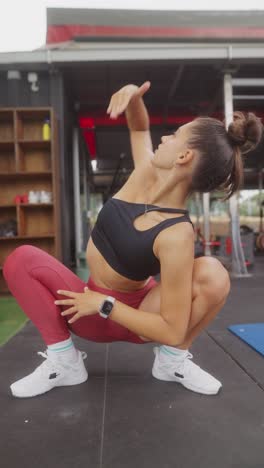 young woman exercising and stretching at an outdoor gym
