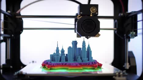 a close-up view of a 3d printer creating a colorful cityscape model, showcasing intricate details and vibrant layers of filament in the process