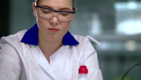 student working in research laboratory. scientist woman writing research results