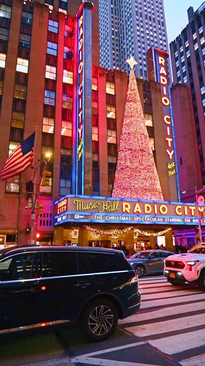 New York, USA, 20 December 2025: Festive vibes in NYC. Visitors explore the vibrant holiday decorations at Radio City Music Hall, featuring a large Christmas tree