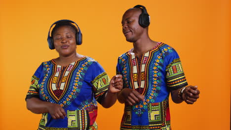 ethnic couple pretending to play air guitar on camera