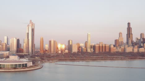 drone view of the chicago skyline from lake michigan during the sunset