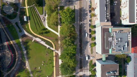 flying above park centralny along the street with cityscape in gdynia, poland