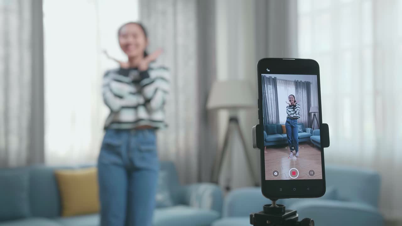Display Smartphone Of Asian Woman Dancing While Shooting Video Content For Social Networks