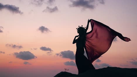 silhouette of sexy, elegant and erotic arabian model performing belly dance on the beach during golden hour. close up