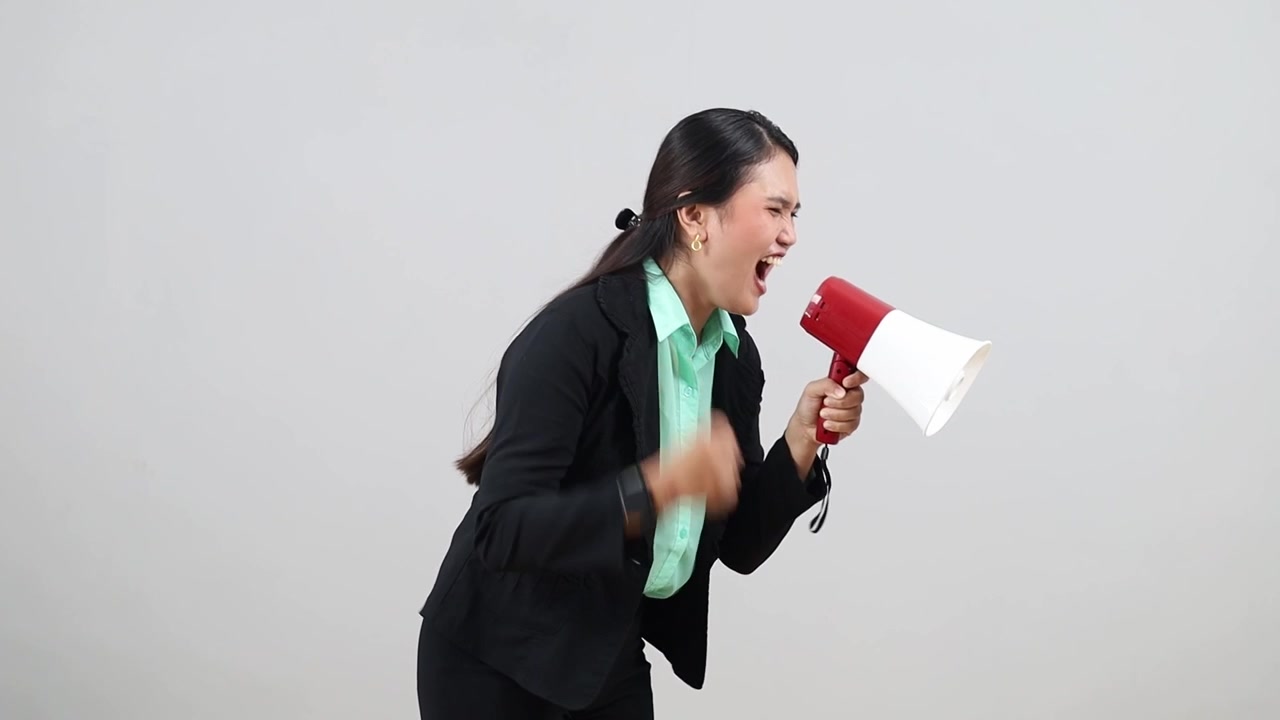 Young employee business woman corporate lawyer wear formal suit hold scream aside megaphone announces discounts sale Hurry up isolated on gray background.