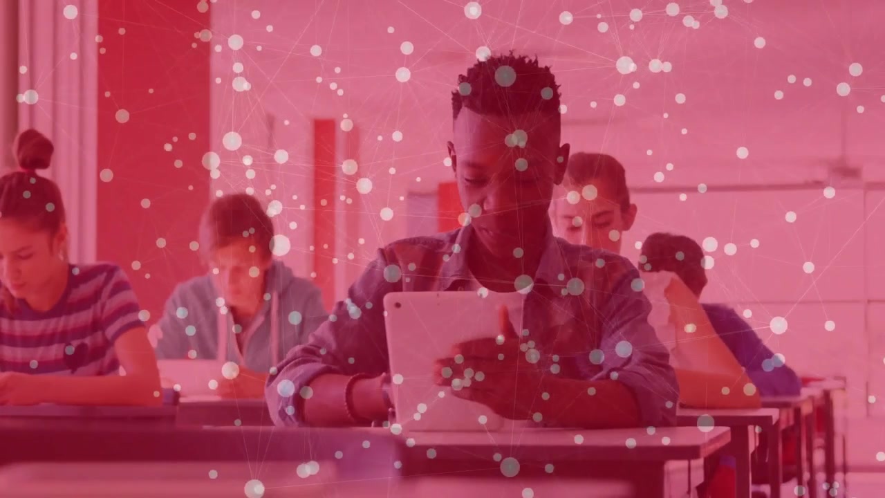 Male student tapping tablet for study in classroom as camera shifting to center him, red overlay
