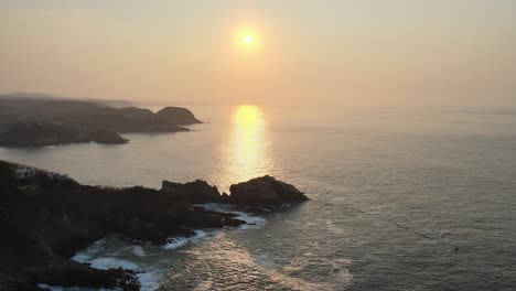 Jib-up-above-sea-and-rocky-shore-at-sunrise-in-Oaxaca's-coast