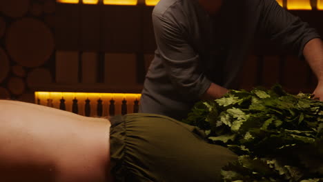traditional sauna back treatment with oak branches