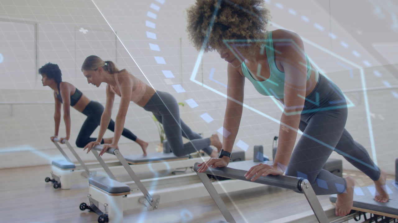 Women exercising on reformer machines with digital data overlay animation