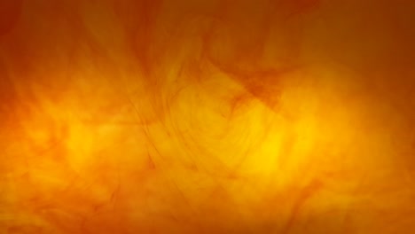 ink swirls creating a fire burning effect with orange and red dye moving in the water, beautiful background color footage