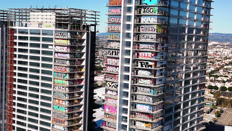 Aerial-View-of-tagged-High-Rises-in-Los-Angeles-with-graffiti-covering-buildings