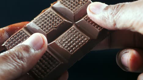 close up of a chocolate bar being broken