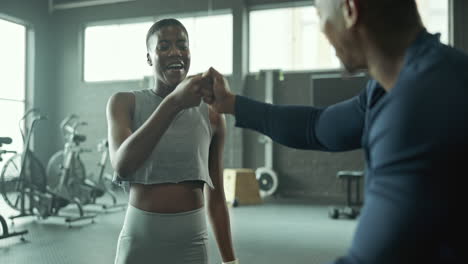 woman working out with personal trainer in gym