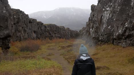 disparo medio siguiendo a una mujer a través de un cañón islandés
